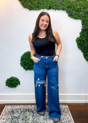 Risen | High Rise Wide Leg Jeans with Distressing & Hidden Patch Detail in Dark Wash