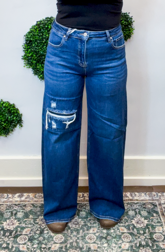 Risen | High Rise Wide Leg Jeans with Distressing & Hidden Patch Detail in Dark Wash