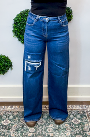 Risen | High Rise Wide Leg Jeans with Distressing & Hidden Patch Detail in Dark Wash