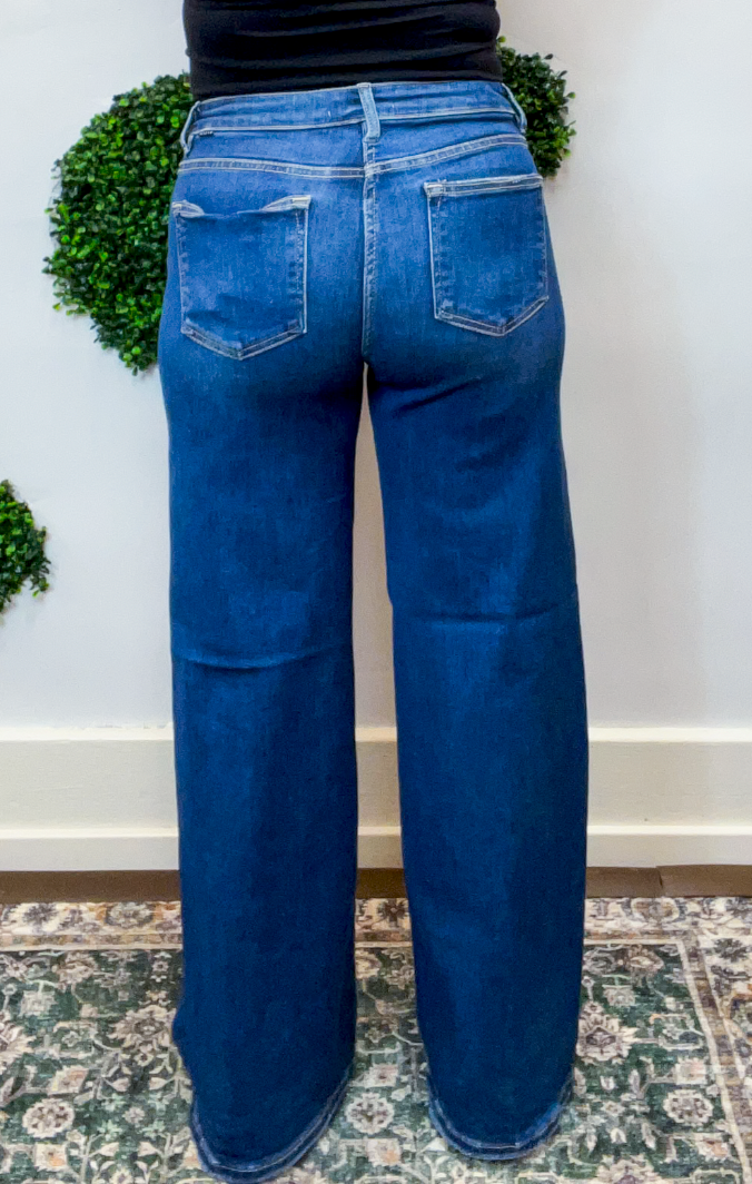 Risen | High Rise Wide Leg Jeans with Distressing & Hidden Patch Detail in Dark Wash